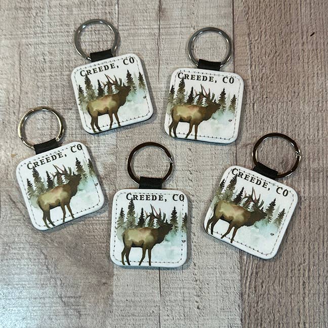 Evergreen trees with  Elk Key Ring 