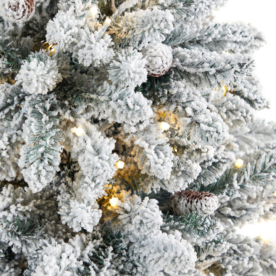 4.5’ Flocked Livingston Fir Artificial Christmas Tree with Pine Cones and 150 Clear Warm LED Lights in Tall White Planter