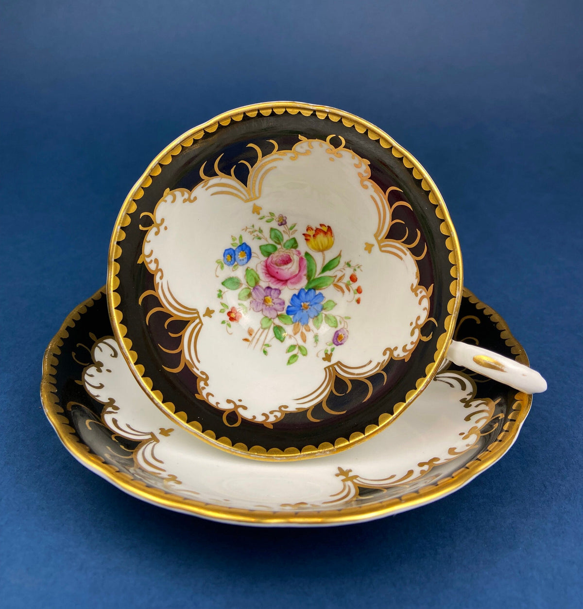 Royal Stafford Cup and Saucer. Black with Gold. Hand Painted Flower Bouquet Inside of Cup and on the Plate.